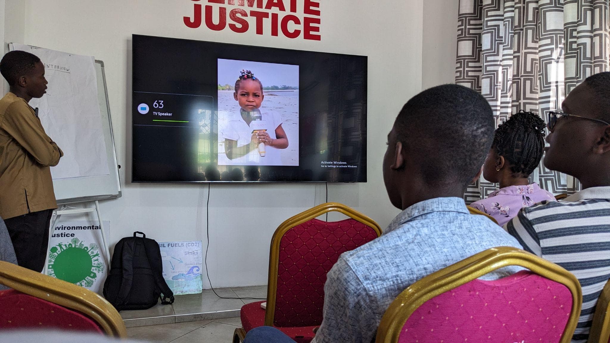 Participants watching a documentary screening in the event room.