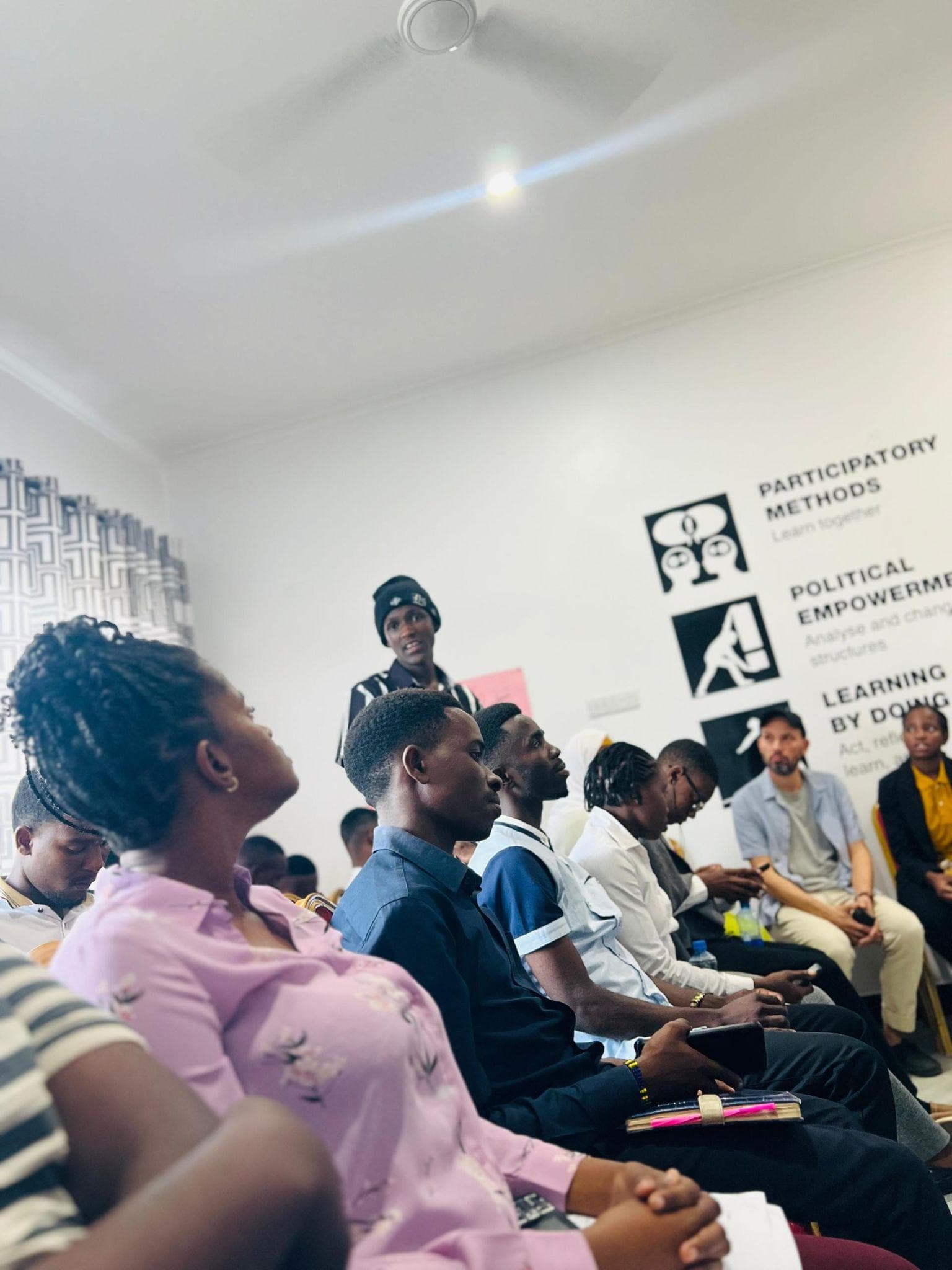 Participants listening to a speaker from their seats in the event room.